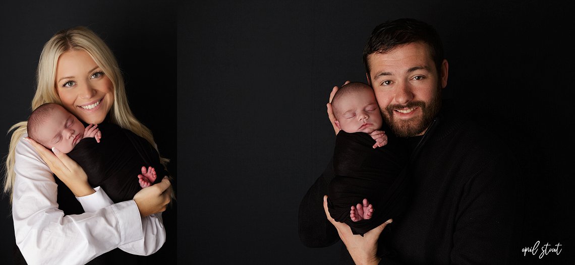 New baby boy captured by April Stout photography on a classic black backdrop with parents