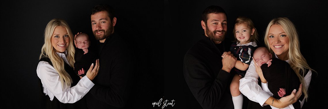 New baby boy captured by April Stout photography on a classic black backdrop with parents and sister