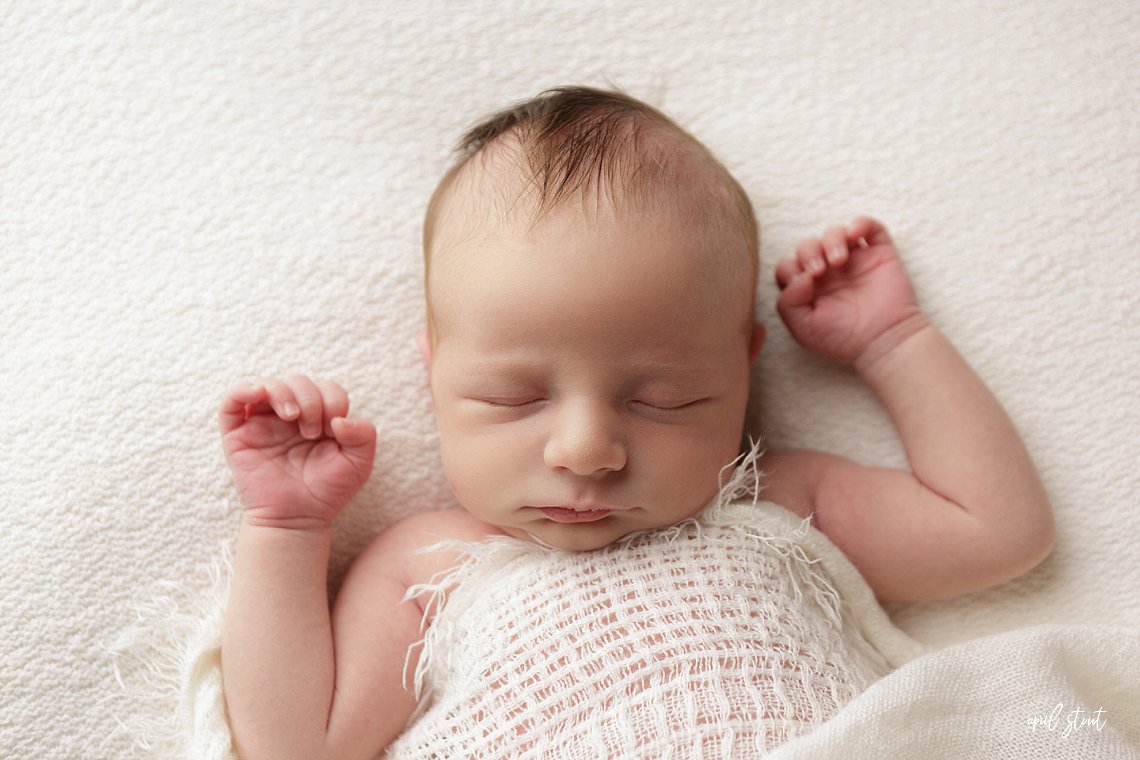 April Stout photographer near Tulsa Oklahoma captures baby boy on simple white backdrop