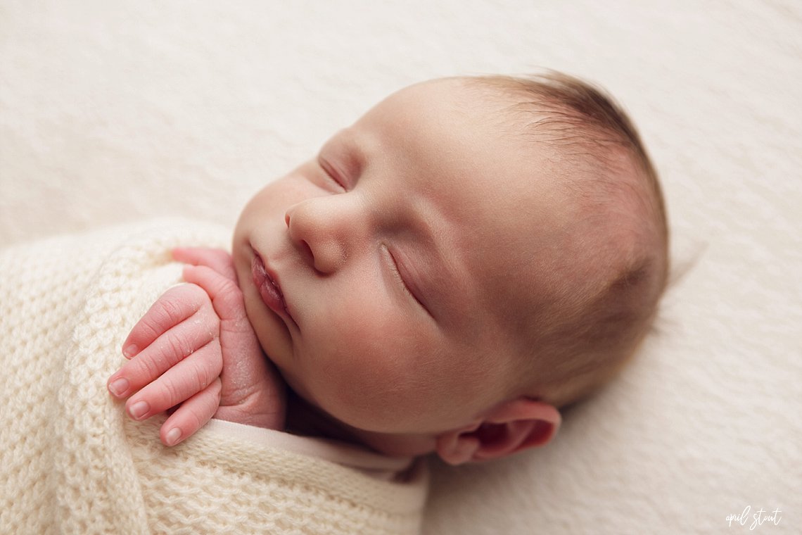 April Stout photographer near Tulsa Oklahoma captures baby boy on simple white backdrop